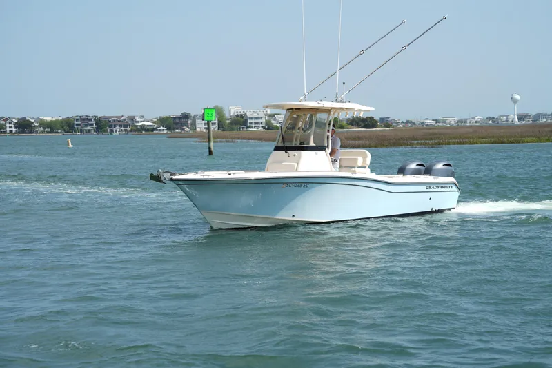 Slide: The Image of 2023 Grady-White Fisherman 257 boat cruising on a scenic waterway. - 7