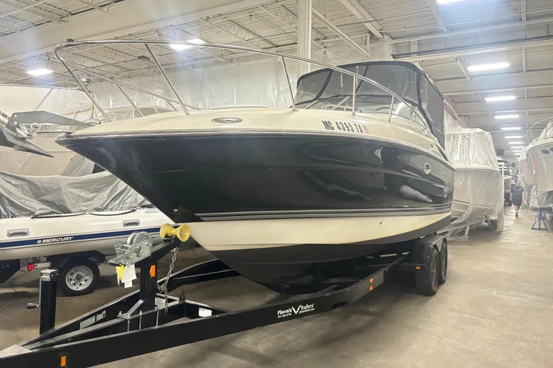 The Image of 2008 Monterey 250 Cruiser boat on trailer in indoor storage facility. - 0