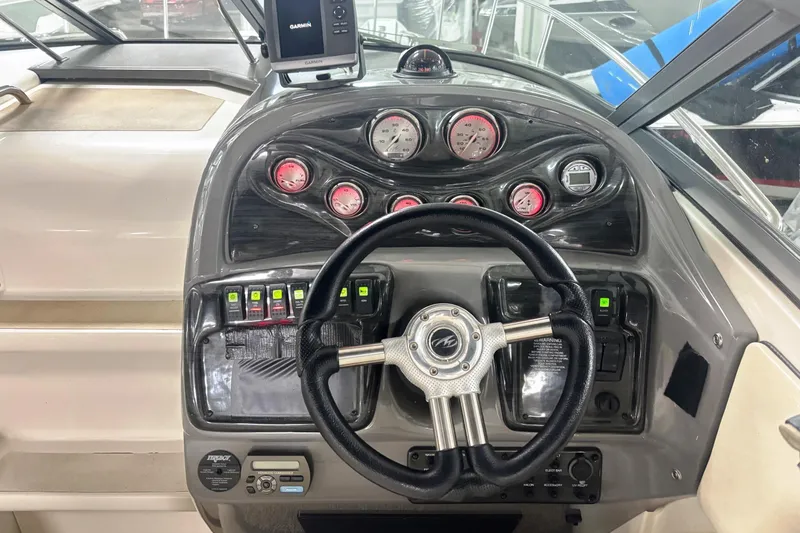 Slide: The Image of Dashboard of a 2008 Monterey 250 Cruiser boat with steering wheel and gauges. - 11