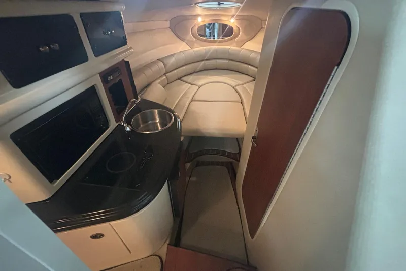 Slide: The Image of Interior of a 2008 Monterey 250 Cruiser boat with kitchenette and seating area. - 12