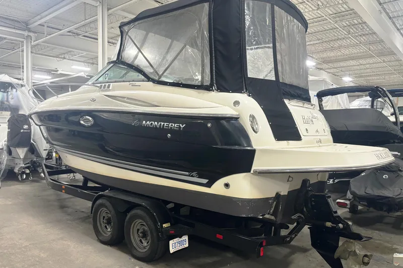 Slide: The Image of 2008 Monterey 250 Cruiser boat in indoor storage on a trailer. - 2