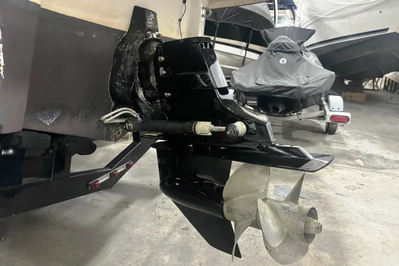 Slide: The Image of 2008 Monterey 250 Cruiser boat propeller and stern drive in a garage setting. - 5