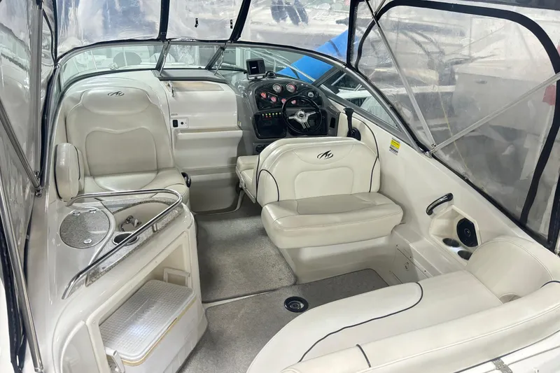 Slide: The Image of 2008 Monterey 250 Cruiser interior with white seating and helm, featuring modern amenities. - 8