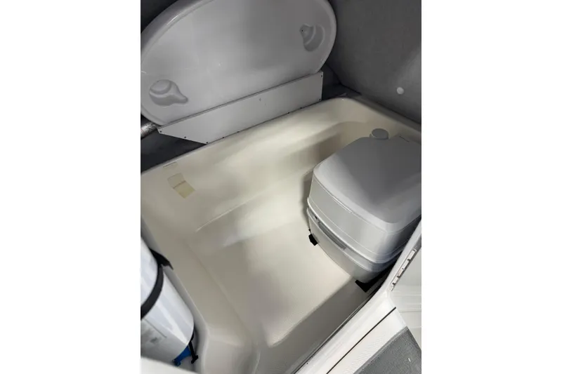 Slide: The Image of 2007 Yamaha SX230 HO boat interior with portable toilet and storage area. - 11