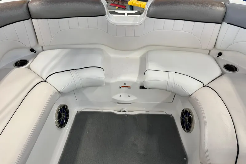 Slide: The Image of 2007 Yamaha Boats SX230 HO interior seating with white upholstery and cup holders. - 5