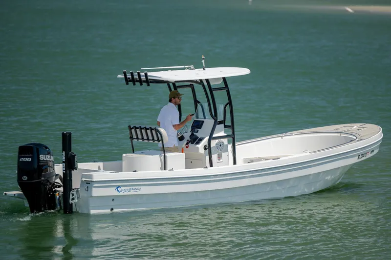 The Image of 2022 Banks Panga 26 boat cruising on calm water with Suzuki outboard motor. - 1