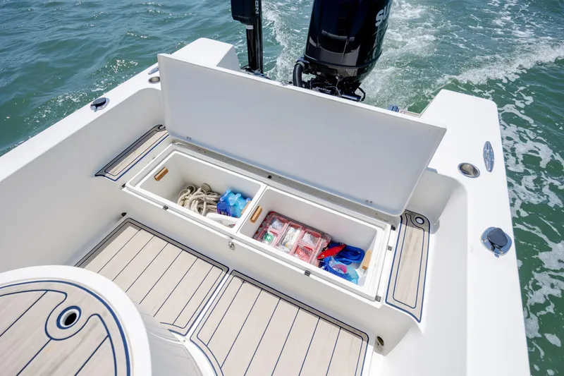 Slide: The Image of 2022 Banks Panga 26 boat with open storage compartment, revealing ropes and supplies. - 10