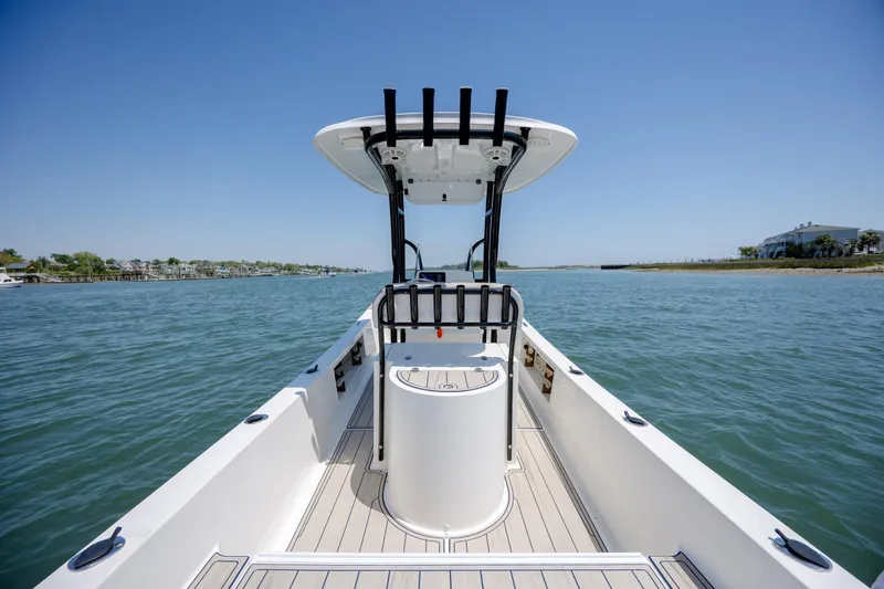 Slide: The Image of 2022 Banks Panga 26 boat on calm water, showcasing sleek design and spacious deck. - 15