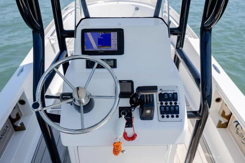 Slide: The Image of Steering console of a 2022 Banks Panga 26 boat with navigation equipment. - 16