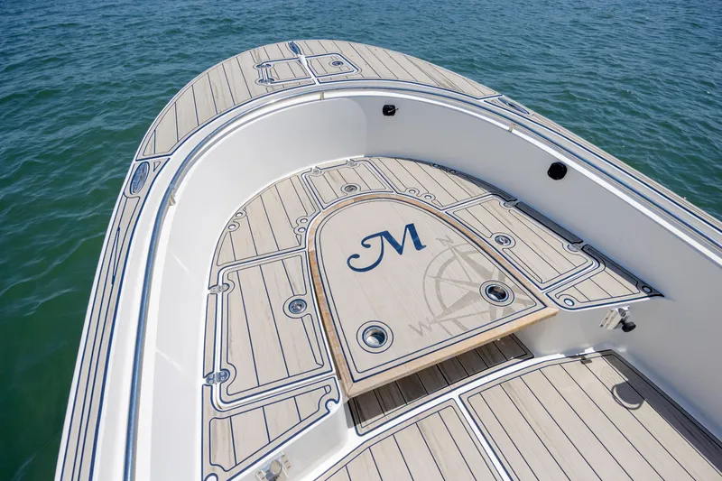 Slide: The Image of Bow of 2022 Banks Panga 26 boat with custom deck design on water. - 17