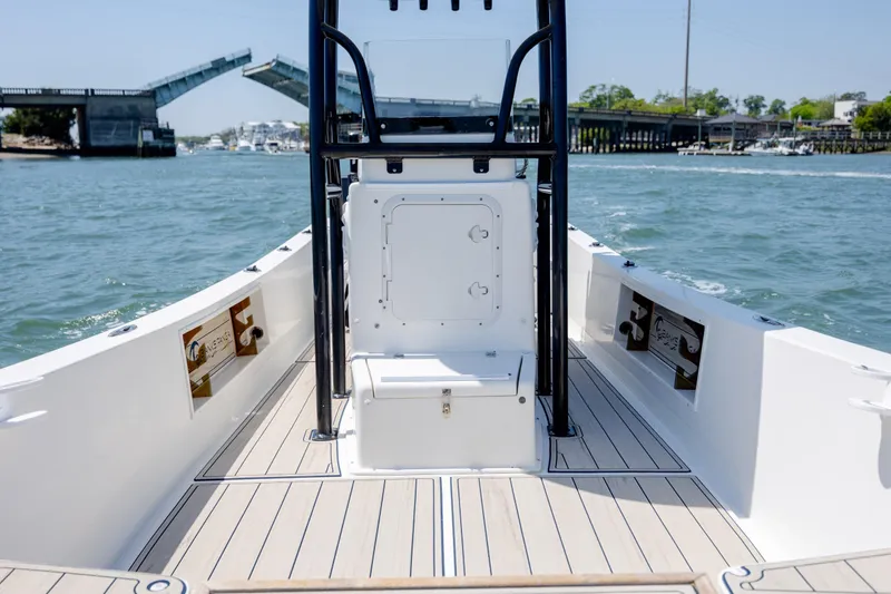 Slide: The Image of 2022 Banks Panga 26 boat interior with open water and drawbridge in background. - 20