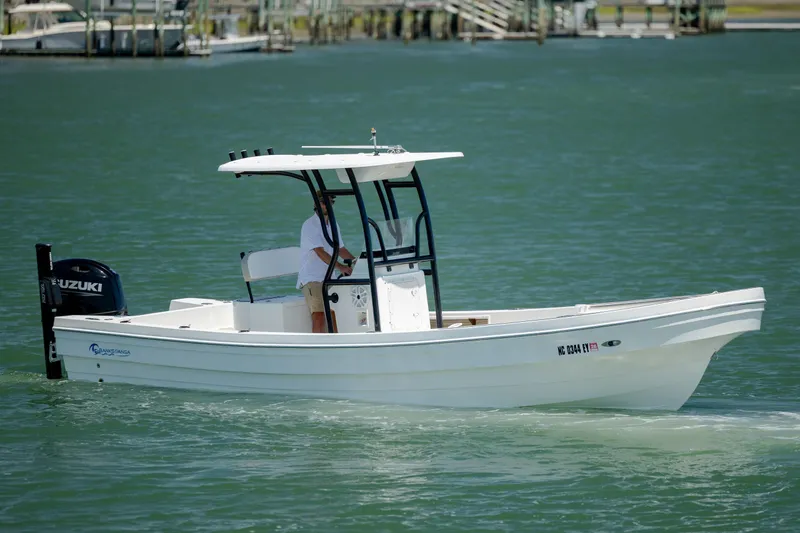 Slide: The Image of 2022 Banks Panga 26 boat cruising on calm water with Suzuki outboard motor. - 3