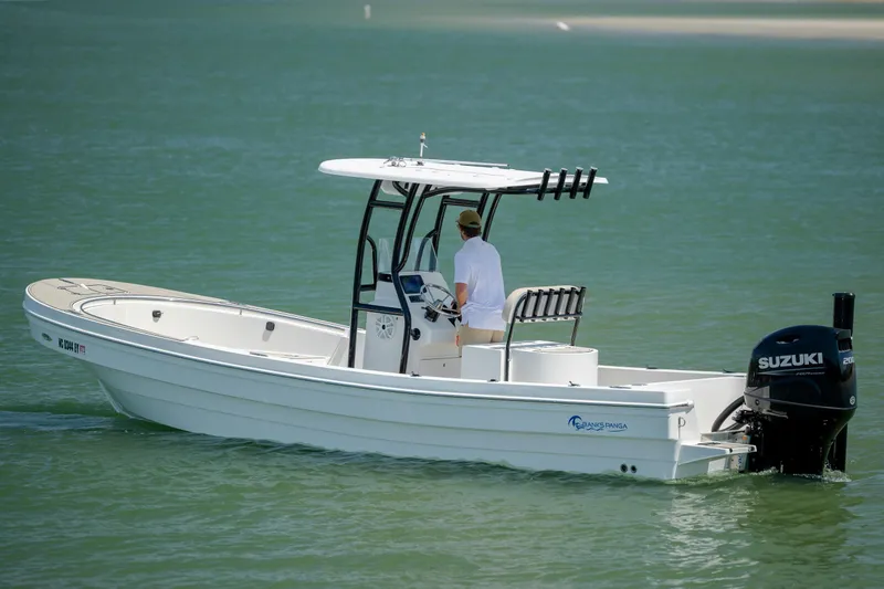 Slide: The Image of 2022 Banks Panga 26 boat with Suzuki outboard motor on calm water. - 4