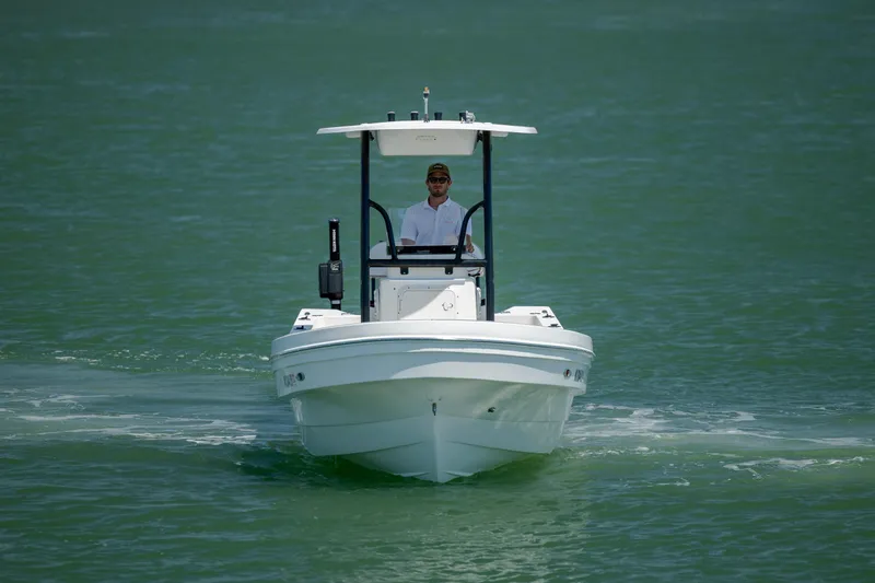 Slide: The Image of 2022 Banks Panga 26 boat cruising on calm green waters. - 6