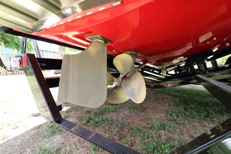 Slide: The Image of 2014 MasterCraft X-25 boat propeller and rudder on trailer, red hull visible. - 10