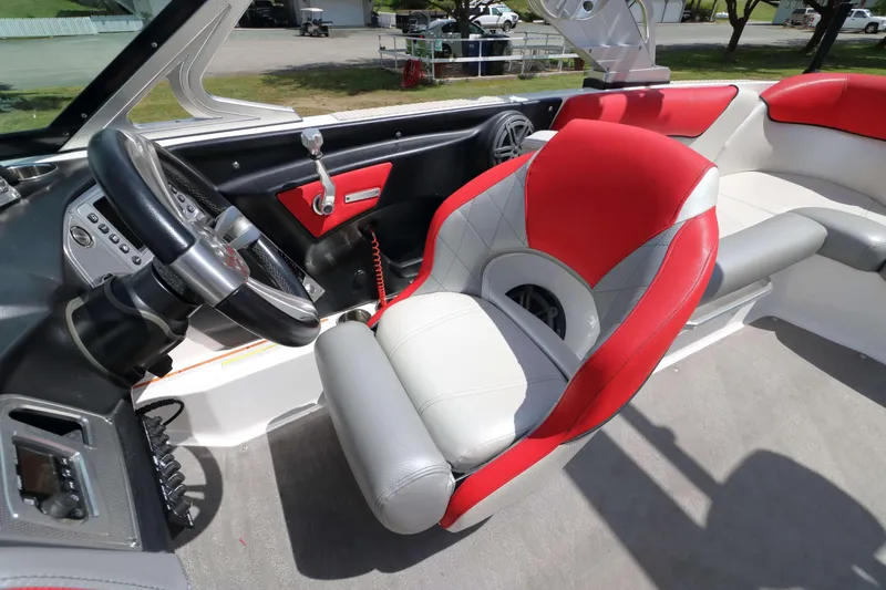 Slide: The Image of Interior of 2014 MasterCraft X-25 boat with red and gray seating and steering wheel. - 19