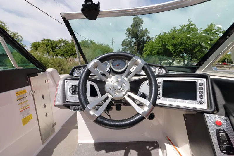 Slide: The Image of 2014 MasterCraft X-25 boat dashboard with steering wheel and control panel. - 20