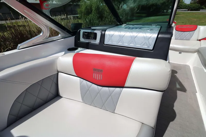 Slide: The Image of 2014 MasterCraft X-25 boat interior with red and gray seating, showcasing luxury design. - 21