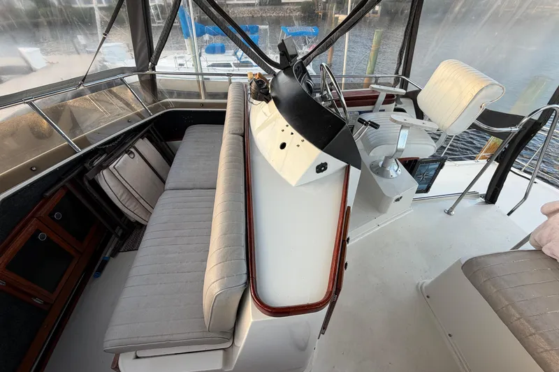 Slide: The Image of 1984 Carver 3607 Aft Cabin Motor Yacht helm with seating and controls. - 10