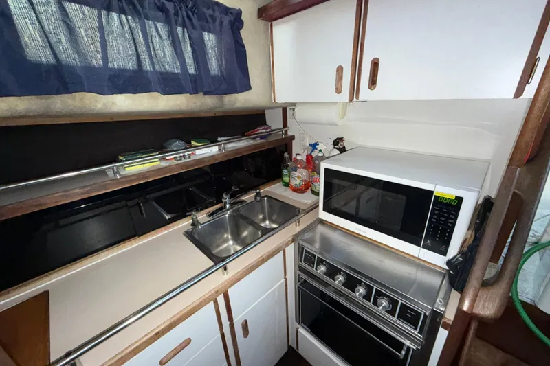 Slide: The Image of Compact kitchen in 1984 Carver 3607 Aft Cabin Motor Yacht with microwave and stove. - 15