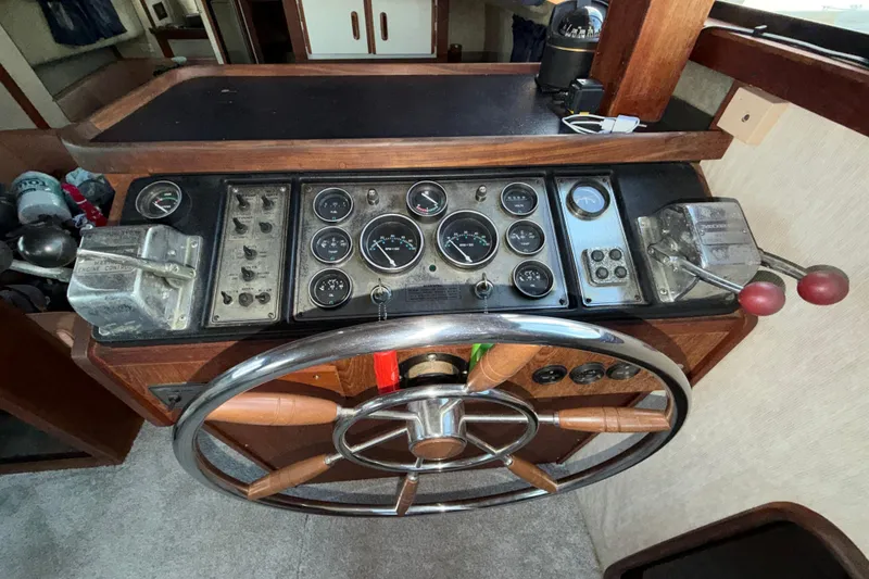 Slide: The Image of 1984 Carver 3607 Aft Cabin Motor Yacht helm with gauges and controls. - 17