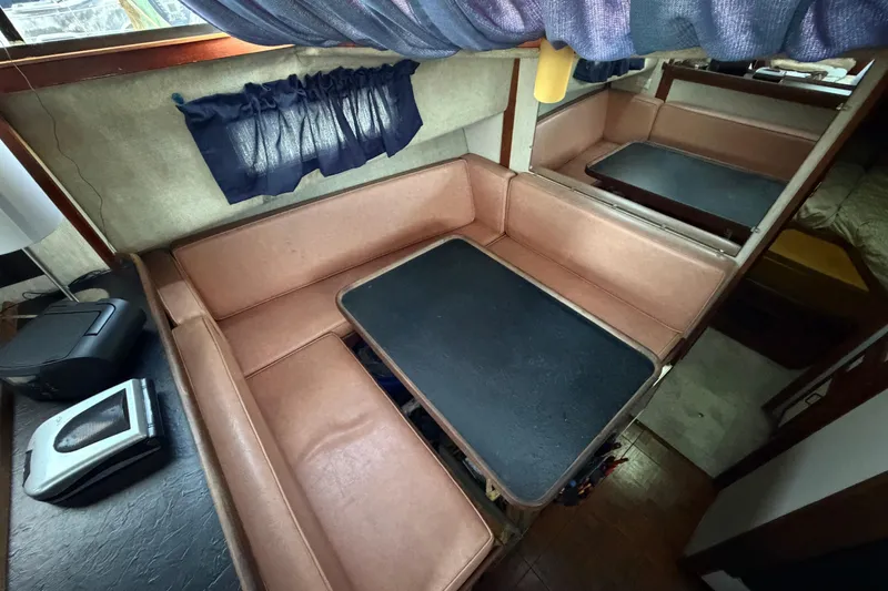 Slide: The Image of 1984 Carver 3607 Aft Cabin Motor Yacht interior with cozy seating and table. - 22