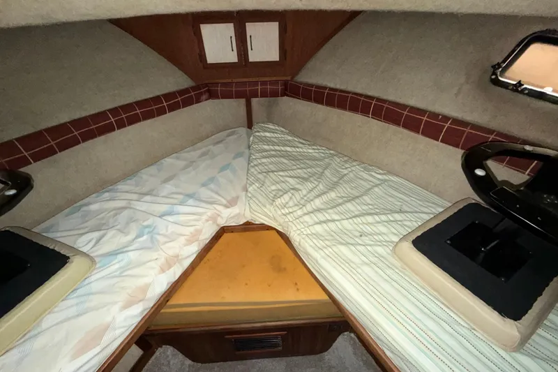 Slide: The Image of 1984 Carver 3607 Aft Cabin Motor Yacht interior with twin beds and wooden cabinetry. - 29