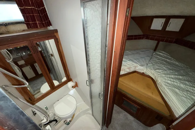 Slide: The Image of 1984 Carver 3607 Aft Cabin Motor Yacht interior with bathroom and sleeping area. - 30