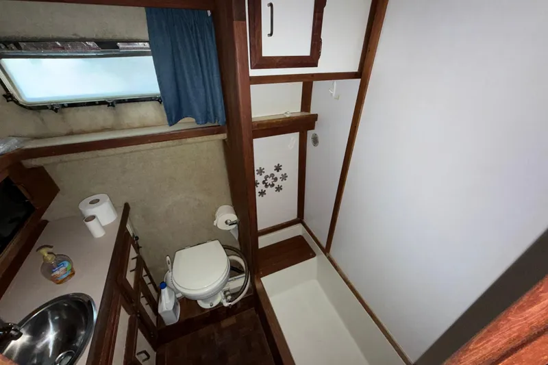 Slide: The Image of 1984 Carver 3607 Aft Cabin Motor Yacht bathroom with sink, toilet, and shower. - 34