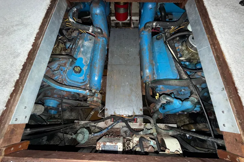 Slide: The Image of Engine compartment of a 1984 Carver 3607 Aft Cabin Motor Yacht, showing dual blue engines. - 37