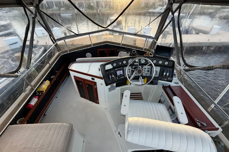 Slide: The Image of 1984 Carver 3607 Aft Cabin Motor Yacht helm with steering wheel and control panel. - 7