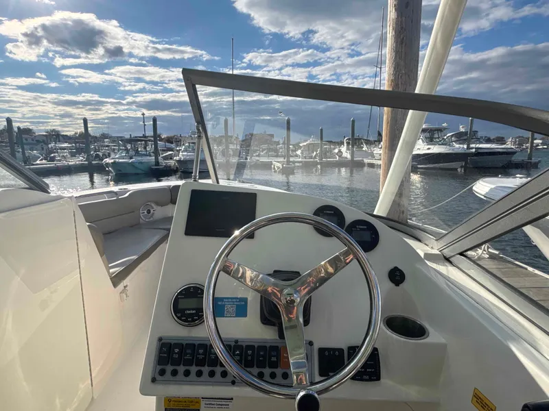 Slide: The Image of Helm of a 2023 Key West 239 DFS boat in the marina. - 5