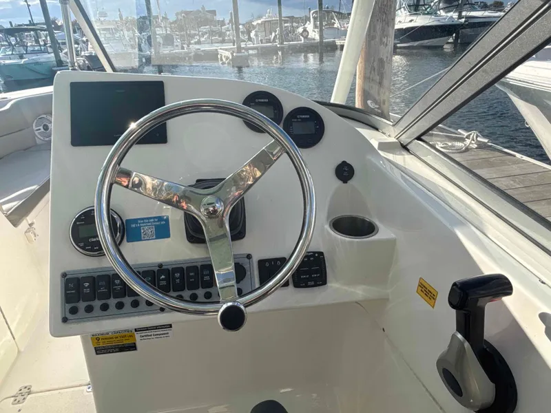 Slide: The Image of Key West 239 DFS boat steering console, 2023 model, docked at marina. - 6