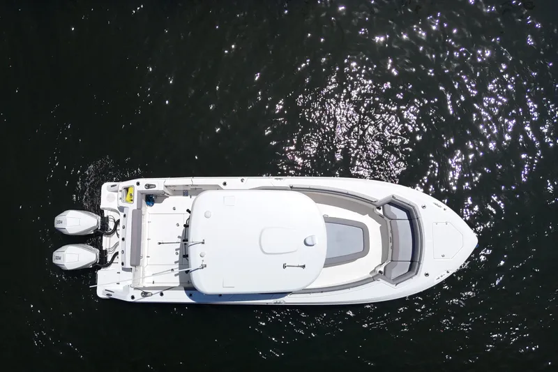 Slide: The Image of Aerial view of 2024 Boston Whaler 280 Outrage boat on shimmering water. - 15