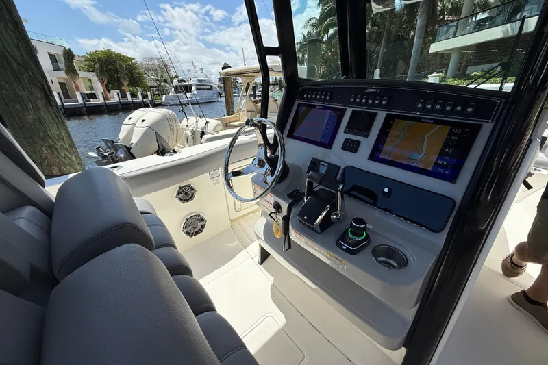 Slide: The Image of 2024 Boston Whaler 280 Outrage helm with advanced navigation displays and controls. - 18