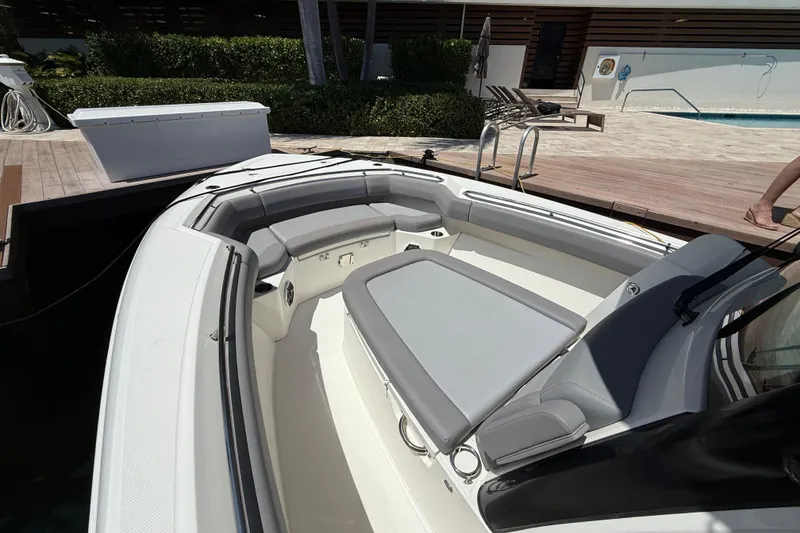 Slide: The Image of 2024 Boston Whaler 280 Outrage boat interior with cushioned seating and modern design. - 22