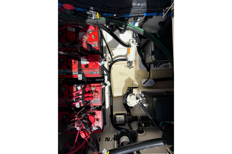 Slide: The Image of 2024 Boston Whaler 280 Outrage battery compartment with wiring and components. - 26