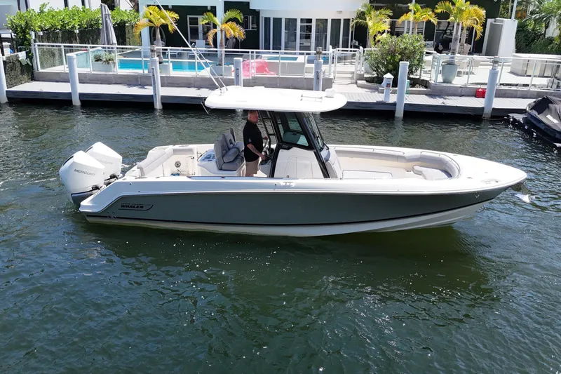 Slide: The Image of 2024 Boston Whaler 280 Outrage boat docked, featuring sleek design and powerful engines. - 5