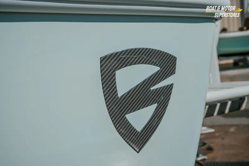 Slide: The Image of 2018 Barker Boatworks 26 Open logo detail with carbon fiber texture. - 14