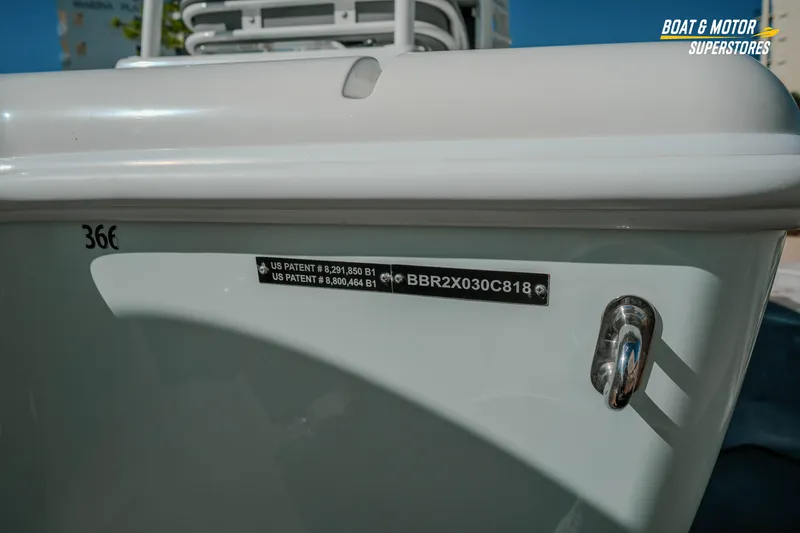 Slide: The Image of 2018 Barker Boatworks 26 Open, close-up of hull with patent details and logo. - 19