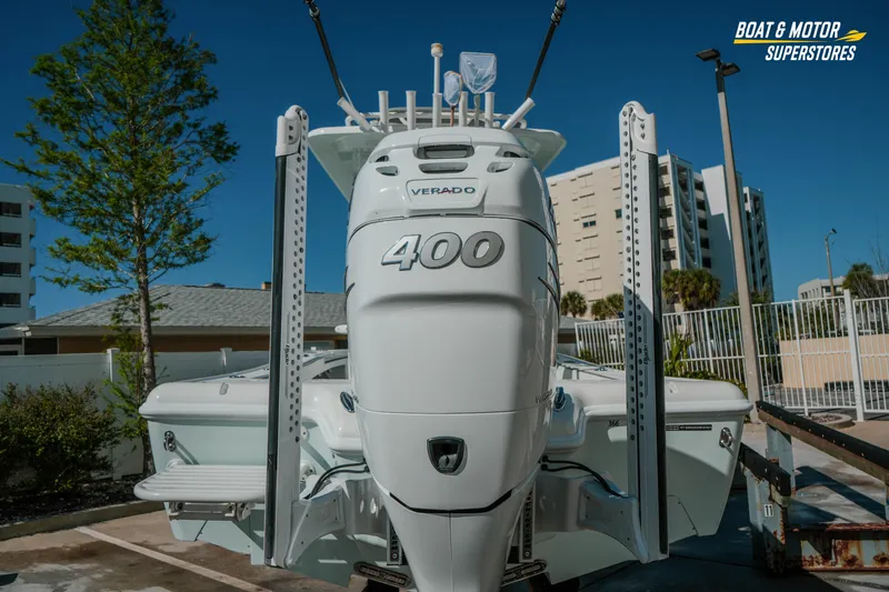 Slide: The Image of 2018 Barker Boatworks 26 Open with powerful Verado 400 engine, parked outdoors. - 2