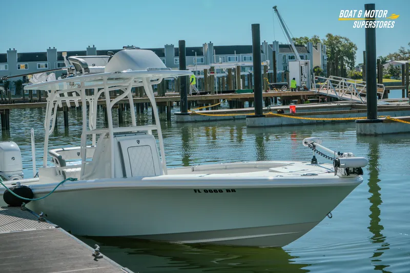 Slide: The Image of 2018 Barker Boatworks 26 Open docked at marina, calm water, clear sky. - 23