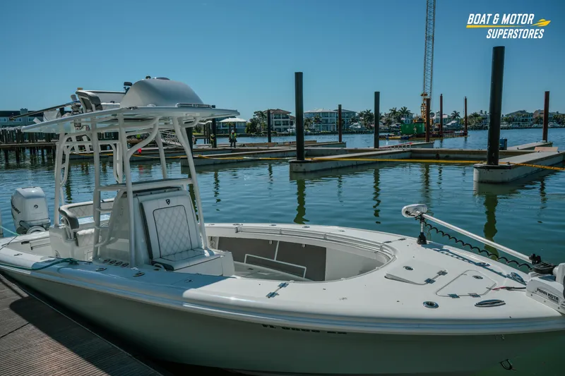 Slide: The Image of 2018 Barker Boatworks 26 Open docked at marina under clear blue sky. - 24