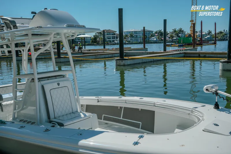 Slide: The Image of 2018 Barker Boatworks 26 Open at marina, showcasing sleek design and spacious deck. - 25