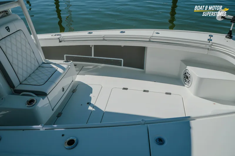Slide: The Image of 2018 Barker Boatworks 26 Open interior with cushioned seating and storage compartments. - 26
