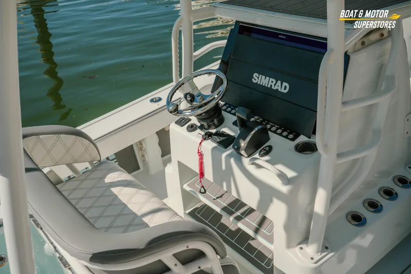 Slide: The Image of 2018 Barker Boatworks 26 Open helm with Simrad display and steering wheel. - 31
