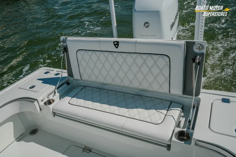 Slide: The Image of 2018 Barker Boatworks 26 Open interior with cushioned seating and water backdrop. - 41