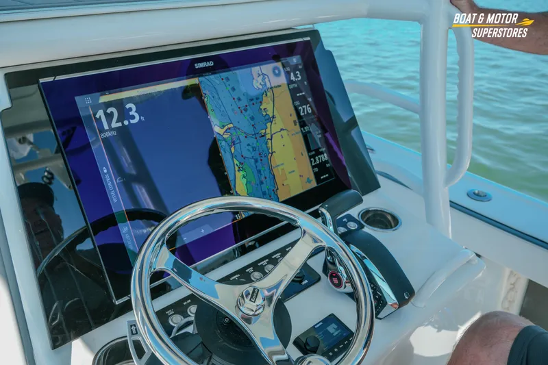 Slide: The Image of 2018 Barker Boatworks 26 Open helm with navigation display and steering wheel. - 44