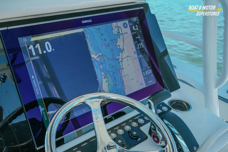 Slide: The Image of 2018 Barker Boatworks 26 Open helm with Simrad navigation display and steering wheel. - 46