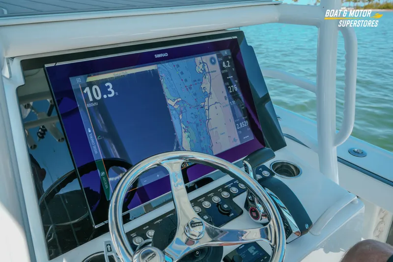 Slide: The Image of Helm of 2018 Barker Boatworks 26 Open with navigation display and steering wheel. - 47